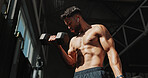 Dumbbells, gym and bodybuilder man with music and serious for training, muscle growth and self care. Earphones, workout playlist and person or health club membership for exercise, strong and fitness