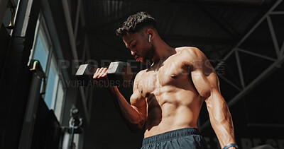 Buy stock photo Dumbbells, gym and bodybuilder man with music and serious for training, muscle growth and self care. Earphones, workout playlist and person or health club membership for exercise, strong and fitness