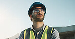 Technician, man and thinking at construction site with helmet, vision and property development idea. Low angle, electrician and person outdoor with safety gear, reflection and decision for building.