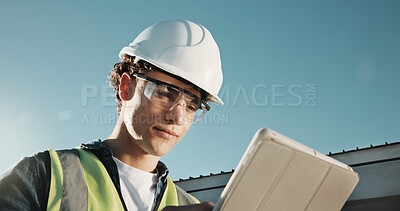 Buy stock photo Engineer, man and tablet at site with PPE, online checklist and quality assurance for construction. Low angle, engineering supervisor and person outdoor with safety gear, tech or building inspection.
