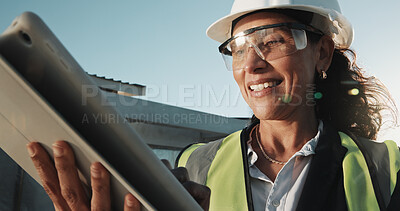 Buy stock photo Happy, woman or engineer at construction site with tablet, PPE or renovation project pass inspection. Low angle, mature person and smile outdoor with tech, building safety standard and compliance.