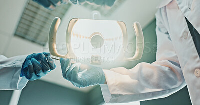 Buy stock photo POV, hands and light with tool for dental procedure, bleeding evaluation or root canal treatment. People, dentist team or probe with surgical lamp for cavity inspection, restorative care or low angle