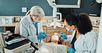 Buy stock photo Dentist, team and patient in clinic for dental suction, procedure or mirror for cleaning tooth decay. Orthodontics, women and help for oral hygiene, tools assistant and medical health with ppe