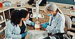 Dentist, team and patient in office for procedure, dental suction or mirror for cleaning tooth decay. Orthodontics, women and help for oral hygiene, tools assistant and medical health with ppe