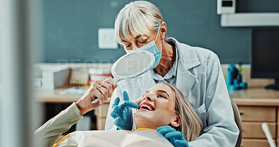 Buy stock photo Happy, mirror and dentist with woman in clinic for teeth cleaning, oral hygiene and check smile. Healthcare, orthodontist and patient with reflection for dental care, appointment and mouth results