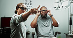 Optometrist, patient or glasses in clinic for eye exam, vision correction or assess sight clarity. Point, doctor and mature man in optometry with refraction test, prescription screening or lens trial