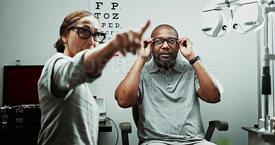 Buy stock photo Optometrist, patient or glasses in clinic for eye exam, vision correction or assess sight clarity. Point, doctor and mature man in optometry with refraction test, prescription screening or lens trial