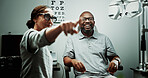 Optometrist, man or glasses in clinic for eye exam, vision correction or assess sight clarity. Point, happy and mature patient in optometry with refraction test, prescription screening or lens trial