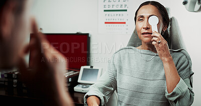 Buy stock photo Optometry, patient and occluder in clinic for eye test, ocular screening or measure visual acuity. Health, optometrist and mature woman in routine checkup for glaucoma exam, eyesight and prescription
