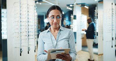 Buy stock photo Optometry, typing and woman on tablet for store inventory, stock and online checklist for frames. Shop, mature and person on digital tech with prescription lens, spectacles and glasses for vision