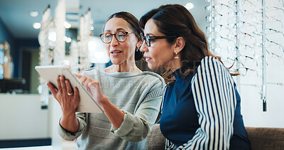 Buy stock photo Optometry, women and tablet in store for consulting, digital lookbook and advice on lens upgrade. Glasses, mature customer or optical assistant with tech for frame planning, color options or pricing