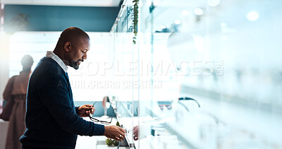 Buy stock photo Glasses, choice and optometry with black man in store for prescription, eye care or spectacle option. Space, ophthalmology and lens shopping with mature person in clinic for vision health and optical