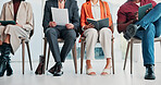 Job interview, legs and hands with resume in waiting room, application or preparing for appointment. Business, vacancy and people with paperwork, recruitment and plan for hiring assessment with tech