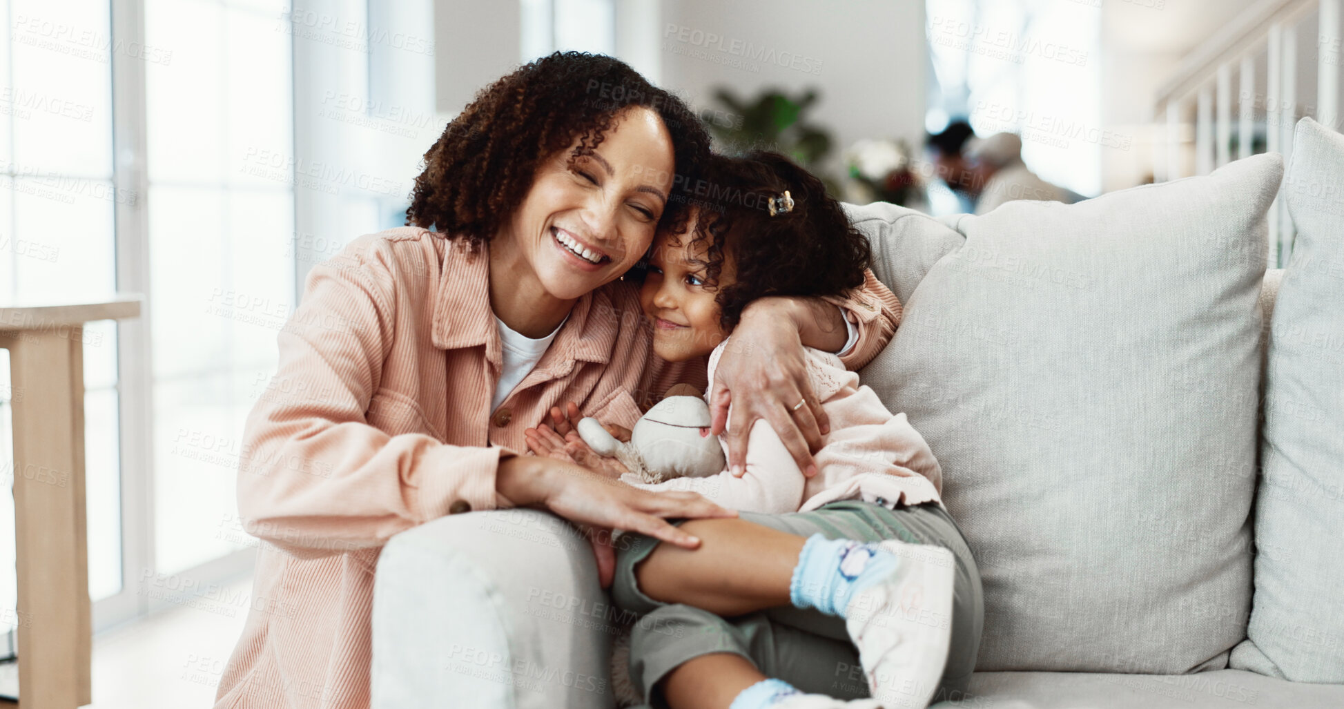 Buy stock photo Happy, mother and hug in home with child, protection and connection for bonding together on weekend. Smile, woman and embrace daughter in living room with love, affection or care for family wellness.