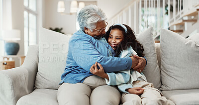 Buy stock photo Happy, grandma and hug in house with child, family wellness and bonding together for weekend visit. Senior woman, smile and embrace girl in living room with grandparent care, support and affection.