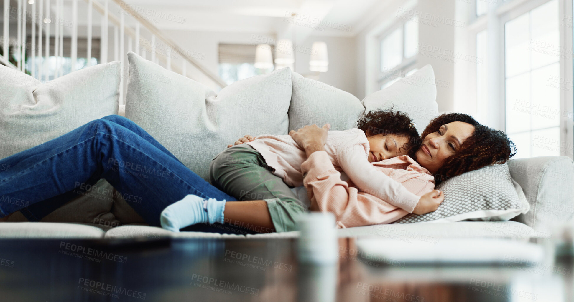 Buy stock photo Mother, child and sleeping in house with sofa, comfortable or bonding together on calm weekend break. Woman, daughter and nap in living room with couch, family love and single parent relax with kid.