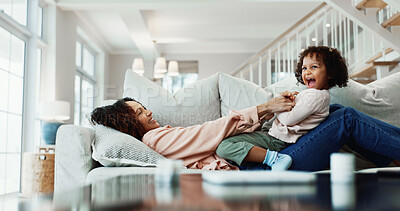 Buy stock photo Mom, laugh and tickle child in house with humor, family time and bonding together for weekend break. Happy, woman relax and play in living room with daughter, funny game and connection for wellness.