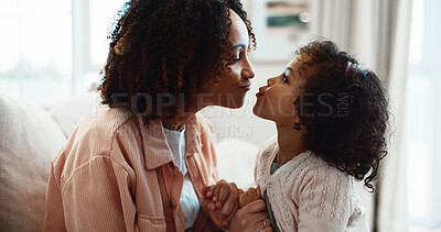 Buy stock photo Mother, kiss and holding hands at house with child, love and playful interaction for bonding. Happy, woman and affection in lounge with daughter, parental care and family connection for weekend break