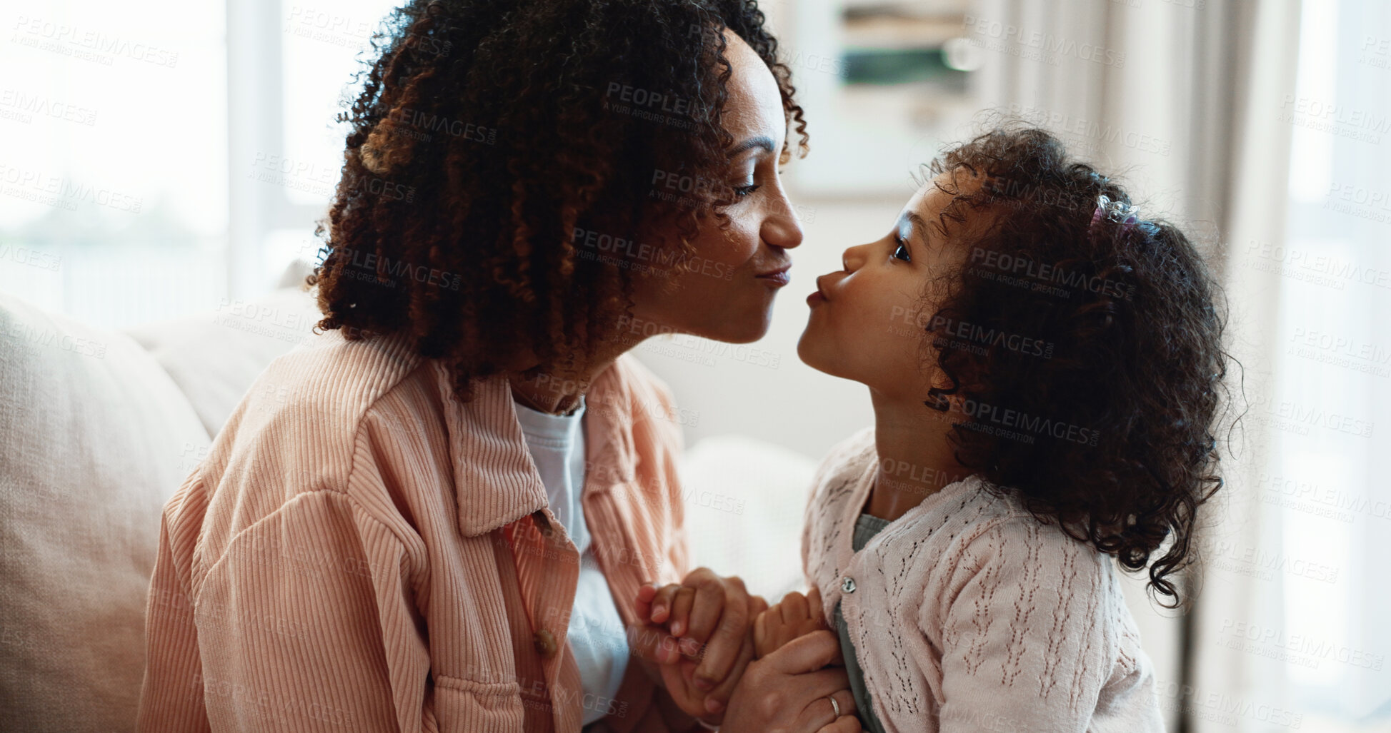 Buy stock photo Mother, kiss and holding hands at house with child, love and playful interaction for bonding. Happy, woman and affection in lounge with daughter, parental care and family connection for weekend break