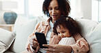 Child, smile and mom with phone in lounge, online and watching video with app subscription in house. Family, love and happy woman with mobile, entertainment and bonding with daughter on break in home