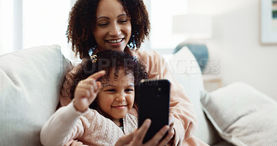 Buy stock photo Child, online and mom with phone in lounge, smile and watching video with app subscription in house. Family, love and happy woman with mobile, entertainment and bonding with daughter on break in home