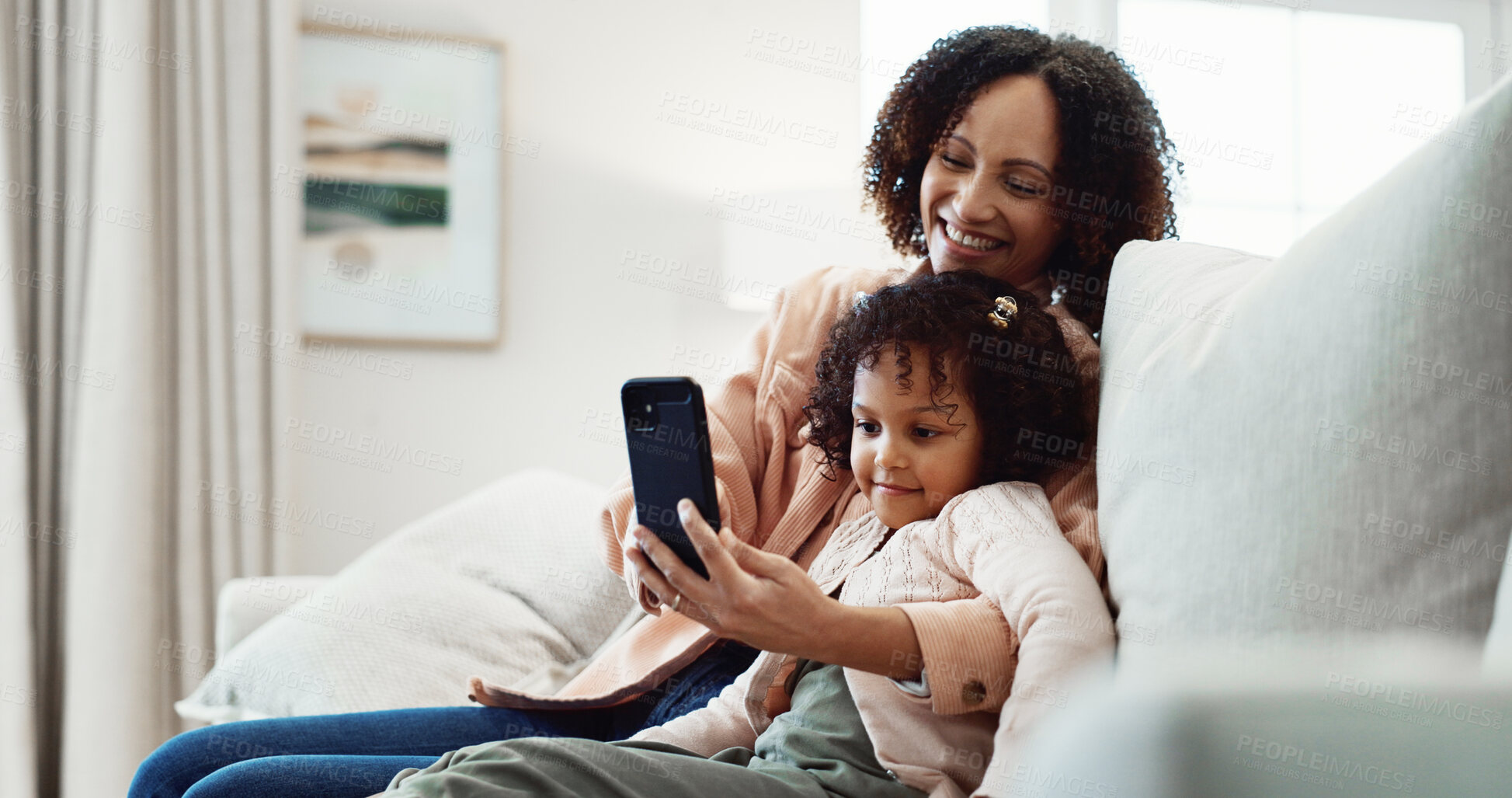 Buy stock photo Mom, laugh and child with phone in lounge, online and watching video with app subscription in house. Family, love and happy woman with mobile, entertainment and bonding with daughter on break in home