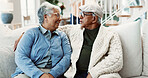 Conversation, old couple and relax on sofa for love, bonding and together with healthy relationship. Man, woman and happy communication in home, break or rest with chat, retirement and care in lounge