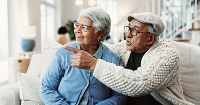 Buy stock photo Pointing, old couple and relax on sofa with talking, bonding and together with healthy relationship. Man, woman and conversation with view or show, break or rest in retirement and connection at home