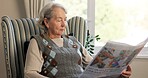 Reading, newspaper and relax with old woman in living room of home for break or information. Morning, article and retirement with elderly person on chair in apartment for media publication or report