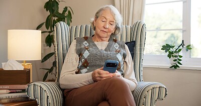 Buy stock photo Phone, reading and senior woman with texting, news and mobile app for contact in home. Elderly person, tech and scroll with chat, notification and social network on lounge couch in retirement