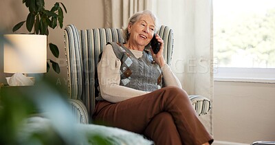 Buy stock photo Phone call, smile and elderly woman on chair in living room for discussion, gossip or communication. Technology, relax and senior person in retirement home with tech for conversation and break