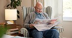 Reading, newspaper and relax with old man in living room of home for break or information. Article, glasses and retirement with elderly person on chair in apartment for media publication or report