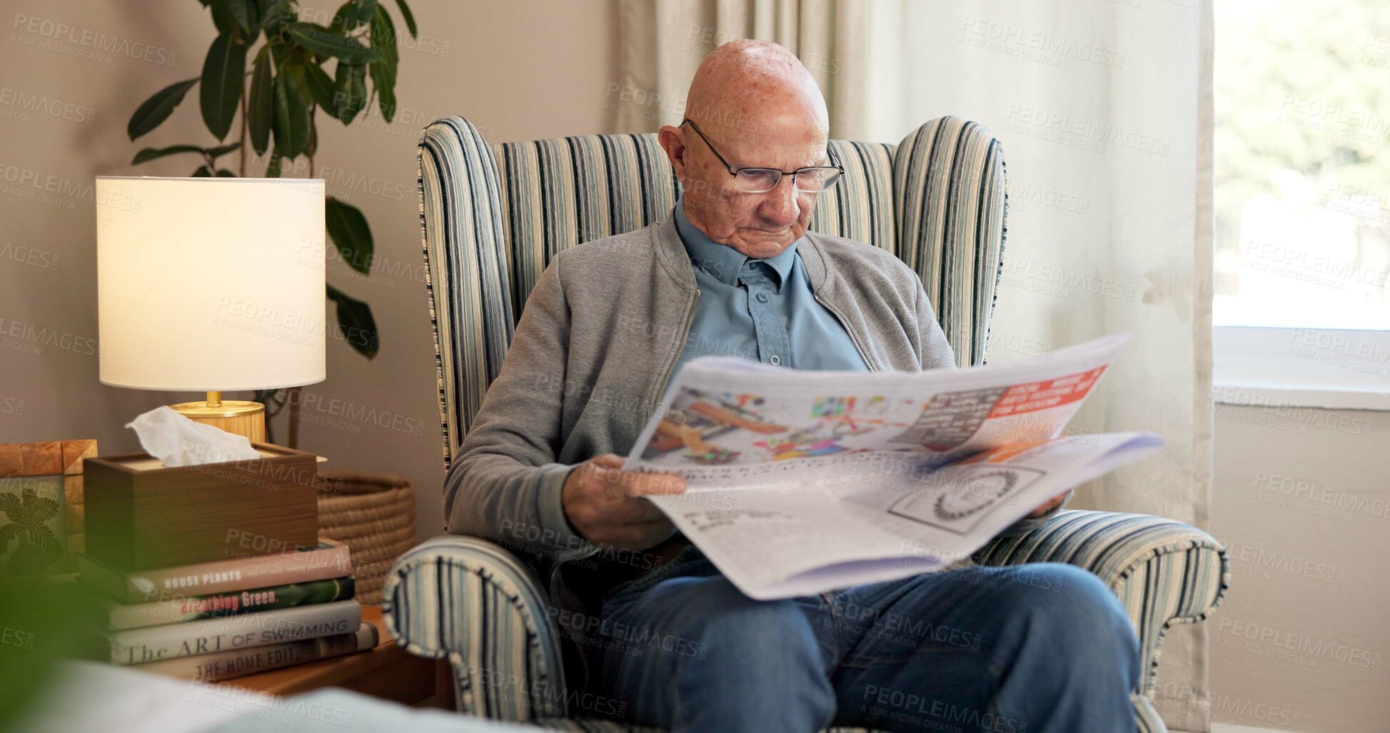 Buy stock photo Reading, newspaper and relax with old man in living room of home for break or information. Article, glasses and retirement with elderly person on chair in apartment for media publication or report