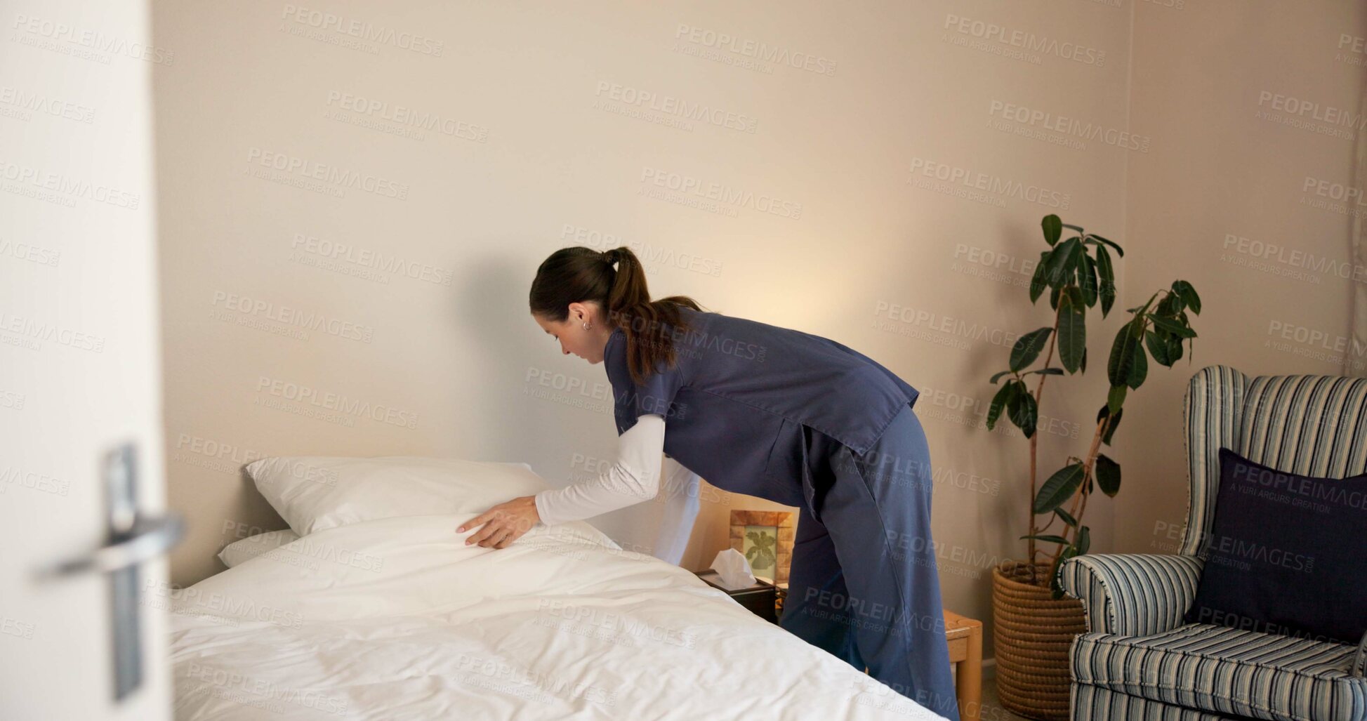 Buy stock photo Nurse, woman and making bed, cleaning and change sheets for hygiene maintenance, chores or service. Bedroom, medical caregiver and fresh blanket for housework, tidy or housekeeping in nursing home