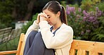 Unhappy, nurse and woman with anxiety at park, think or contemplating decision with regret in nature. Outdoor, caregiver and person with depression, reflection and remembering bad memories and stress