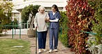 Nurse, cane and senior woman in outdoor garden for mobility, exercise or support together. Elderly, female person or caregiver helping patient with walking stick for assisted living or balance