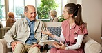 Senior, man and discussion with nurse in retirement home for healthcare, routine or schedule. Woman, caregiver or male person on sofa for elderly foster care or planning checklist in old age house