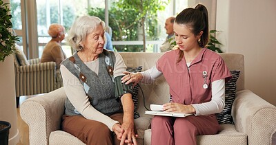 Buy stock photo Blood pressure, consultation and nurse with senior woman on sofa in nursing home for diagnosis. Hypertension, support and healthcare worker with elderly patient for medical checkup with advice.