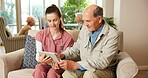 Senior, man or nurse with tablet on sofa for online healthcare, help or assistance in retirement home. Elderly, female person or showing app with patient for Telehealth, web or connection in house