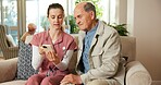 Senior, man and nurse with phone in retirement home for online healthcare, advice or web help. Woman, caregiver or male person on sofa with smartphone for elderly care or Telehealth app in house