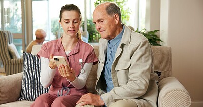 Buy stock photo Senior, man and nurse with phone in retirement home for online healthcare, advice or web help. Woman, caregiver or male person on sofa with smartphone for elderly care or telehealth app in house