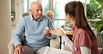 Senior, man or nurse with pills in retirement home for healthcare, prescription or medical dosage. Caregiver, male person or discussion with pharmaceuticals for symptoms, advice or treatment in house