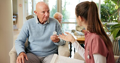Buy stock photo Senior, man or nurse with pills in retirement home for healthcare, prescription or medical dosage. Caregiver, male person or discussion with pharmaceuticals for symptoms, advice or treatment in house