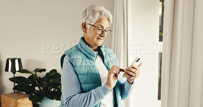 Buy stock photo Old woman, relax and reading at house with phone, social media and browsing online for bingo. Senior person, scroll or review in home with mobile app, internet search and download games on retirement