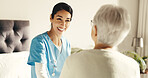 Senior, woman or nurse with patient in bedroom for medical advice or assistance in retirement home. Female person, healthcare worker or caregiver with smile for elderly care, aid or nursing in house