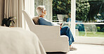 Senior, woman and thinking in retirement home with tablet, ebook and internet connectivity by window. Calm, elderly person and relax in chair with tech, contemplation and reflection for online story.