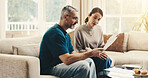 Tablet, documents and couple on sofa in home with planning budget, savings or finance research. Paperwork, digital technology and mature man with woman in living room for discussion for investment.