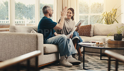 Buy stock photo Tablet, high five and couple on sofa in home with planning budget, savings or finance research. Happy, digital technology and man with woman in living room for discussion on app for investment.