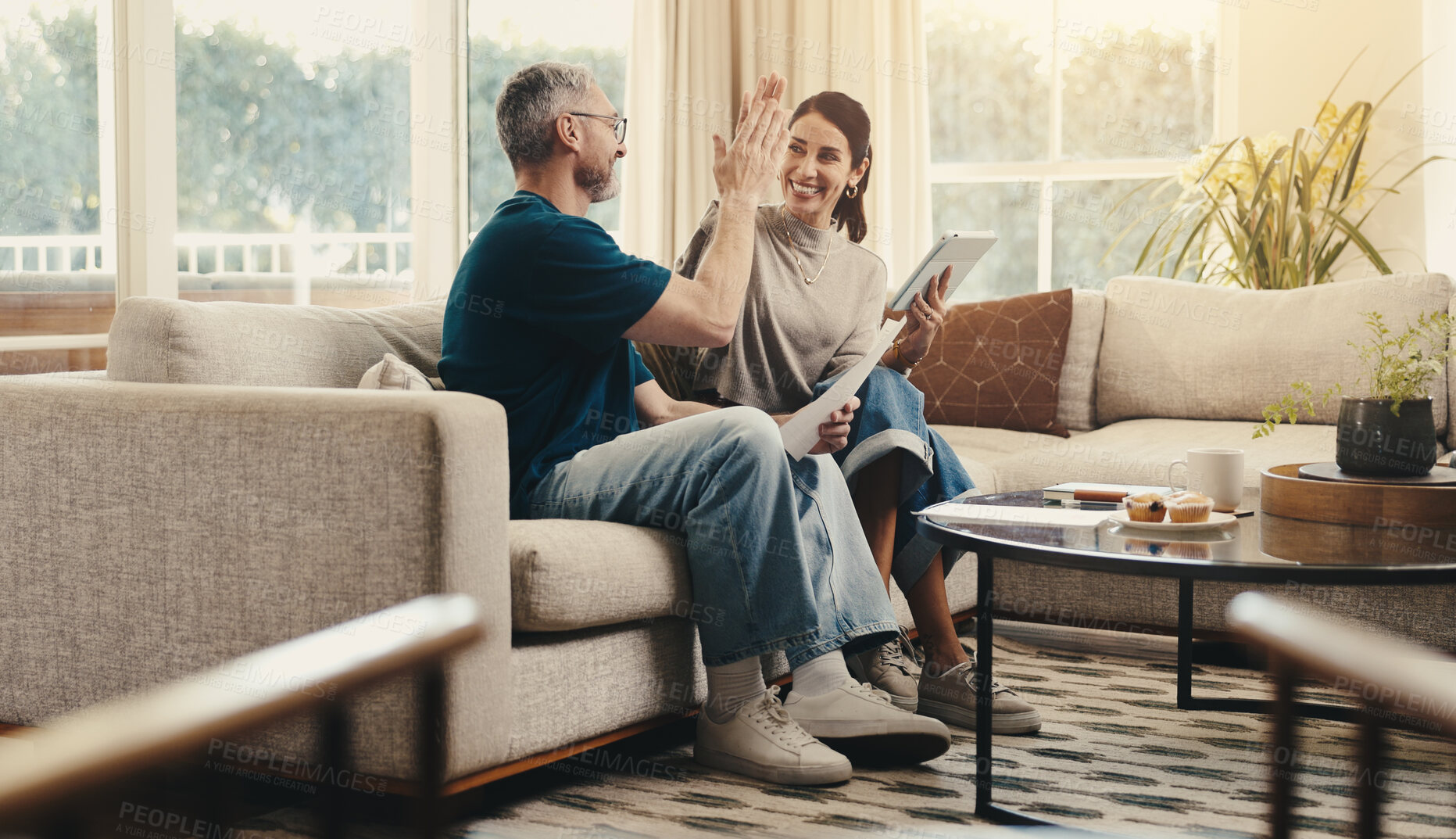 Buy stock photo Tablet, high five and couple on sofa in home with planning budget, savings or finance research. Happy, digital technology and man with woman in living room for discussion on app for investment.