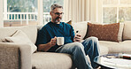 Smile, man and relax at house with phone, social media and browsing online for latest movies. Happy, mature person and coffee in home with mobile app, internet search and streaming for film watchlist